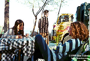 Two girls, Mimar Sinan University art students, sit in a Findikli seaside park and drink tea in Istanbul, Turkey.