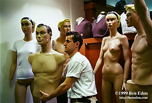 A Turkish shopkeeper moves a torso of a male figurine during a late-night shift in a fashion store on Istiklal Avenue in Taksim, Istanbul, Turkey