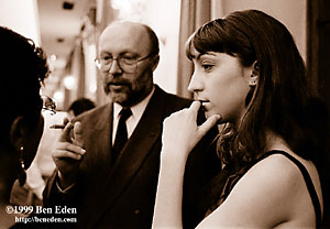 A pretty Jewish girl stands pensively while her father holds a conversation with a woman at Chanukah (Hanukah) charity ball held in the Rudolph Gallery at Prague Castle, Czech Republic.