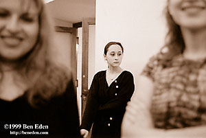 Three Jewish girls - two smiling and one sad, on the verge of tears - at a Chanukah (Hanukah) charity ball held in the Rudolph Gallery at Prague Castle, Czech Republic.