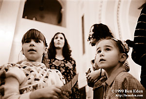 Two little Jewish girls look up with interest at a Chanukah (Hanukah) party, organized by Prague Jewish Community.