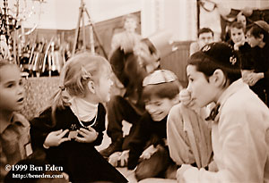 Jewish children - two girls and two boys in kippa - play during a Chanukah (Hanukah) party in Prague Jewish community.
