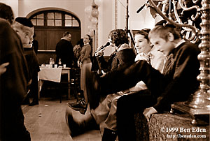 Two Jewish boys wearing kippa attempt to kick other kids in the behind at a Chanukah (Hanukah) children's party held in Prague, Czech Republic Jewish Community's eating hall.