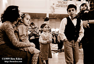 Jewish children - twin sisters, a boy and a little girl held by her mother at a Chanukah (Hanukah) children's party held in Prague, Czech Republic Jewish Community's eating hall.