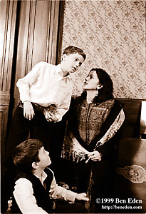 Prague Jewish mother talks to her walkman-wearing teenage son while her other child tugs at her dress for attention at a Chanukah (Hanukah) celebration.