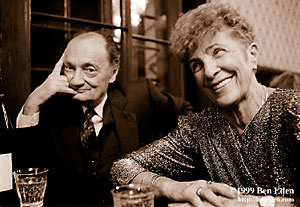 A well-dressed older Jewish couple sitting at a table close to each other at a Chanukah (Hanukah) celebration held in Prague, Czech Republic Jewish Community's eating hall.