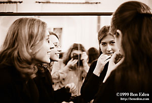 Two Jewish girls look at each other in the mirror while their photograph is being taken at a Chanukah (Hanukah) celebration held in Prague, Czech Republic Jewish Community's eating hall.