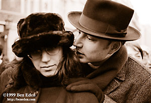 An orthodox Jewish man tenderly whispers in the ear of his wife while they stand in Male namesti, Prague, Czech Republic, waiting for the Chanukiah (Hanukiah, Menorah) to be lit as Chanukah (Hanukah) starts.