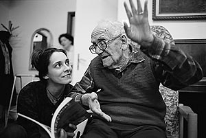 Vilem Zvillinger, a Czech Jewish Holocaust survivor,  raises his hand as he discusses a book with Klarka, his favorite intern caretaker in the communal room of the Charles Jordan retirement home in Prague, Czech Republic.