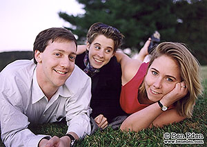 Candid engagement portraits on the lawn