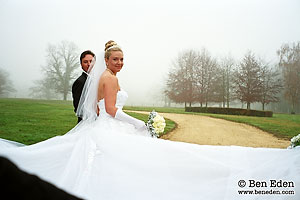 Newlywed couple stroll through the park