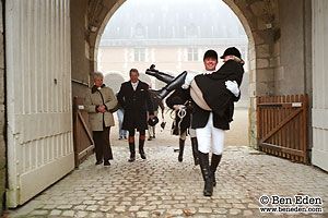 Groom carries the bride on the way to the stables