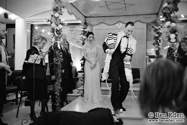 Mazel Tov: the groom breaks a glass by stepping on it