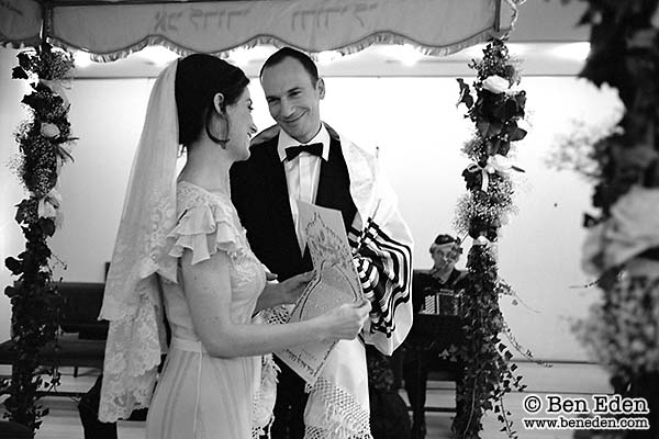 The bride receives the Ketubah from the groom under the Chuppah