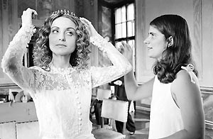 Bride, helped by her sister, adjusts her hair